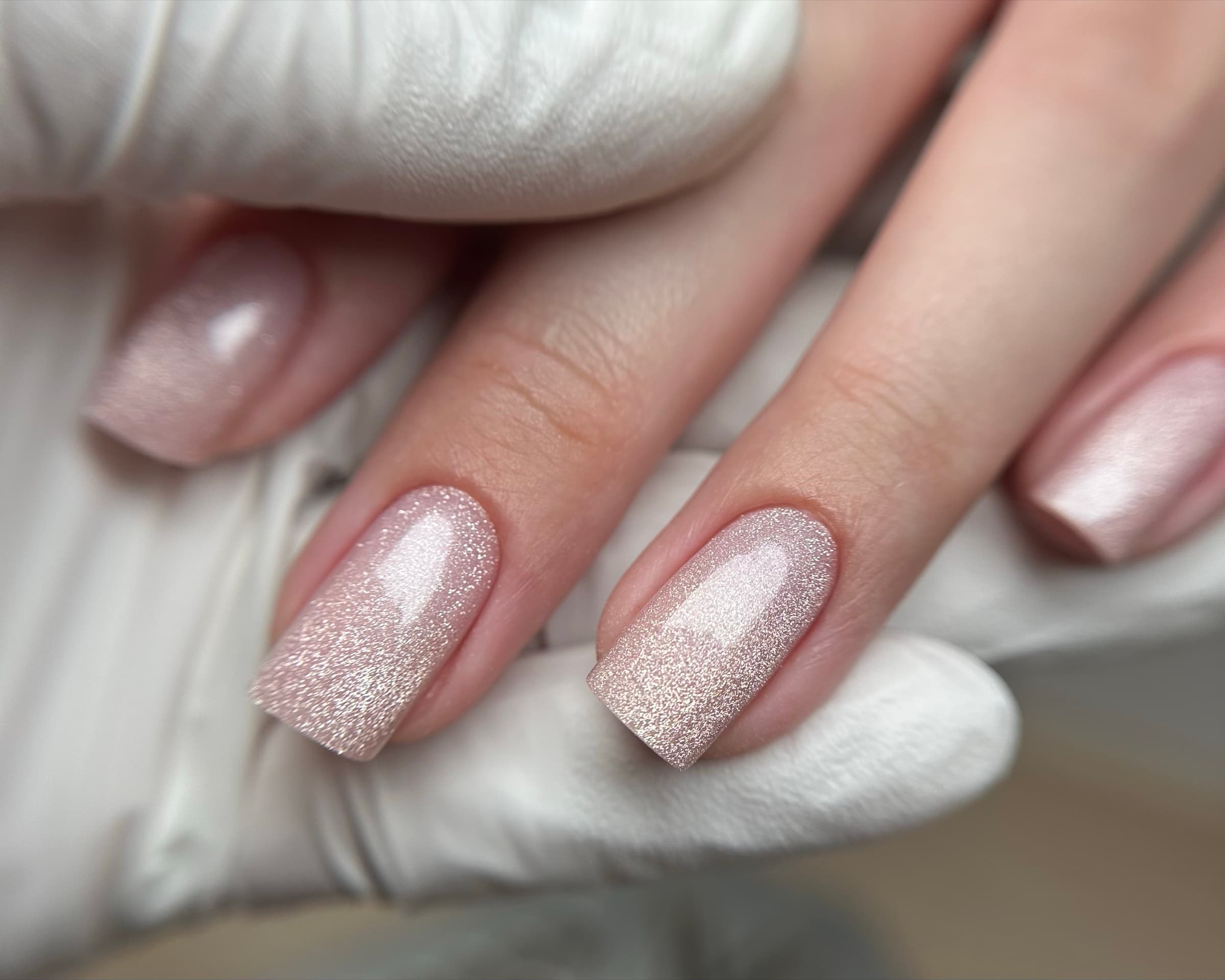 Shimmering rose gold glitter manicure on square nails