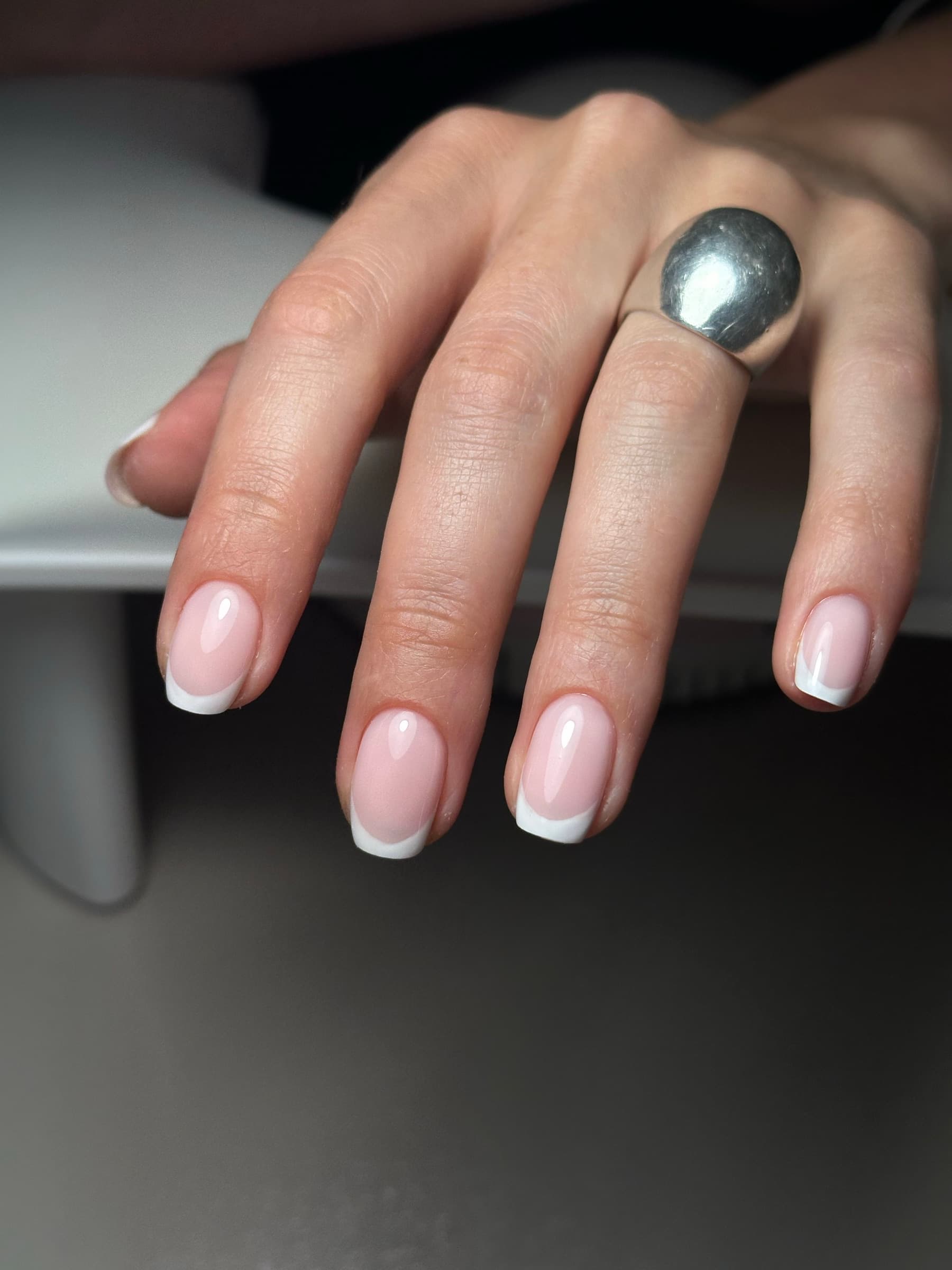 Classic white French tip manicure on medium oval nails
