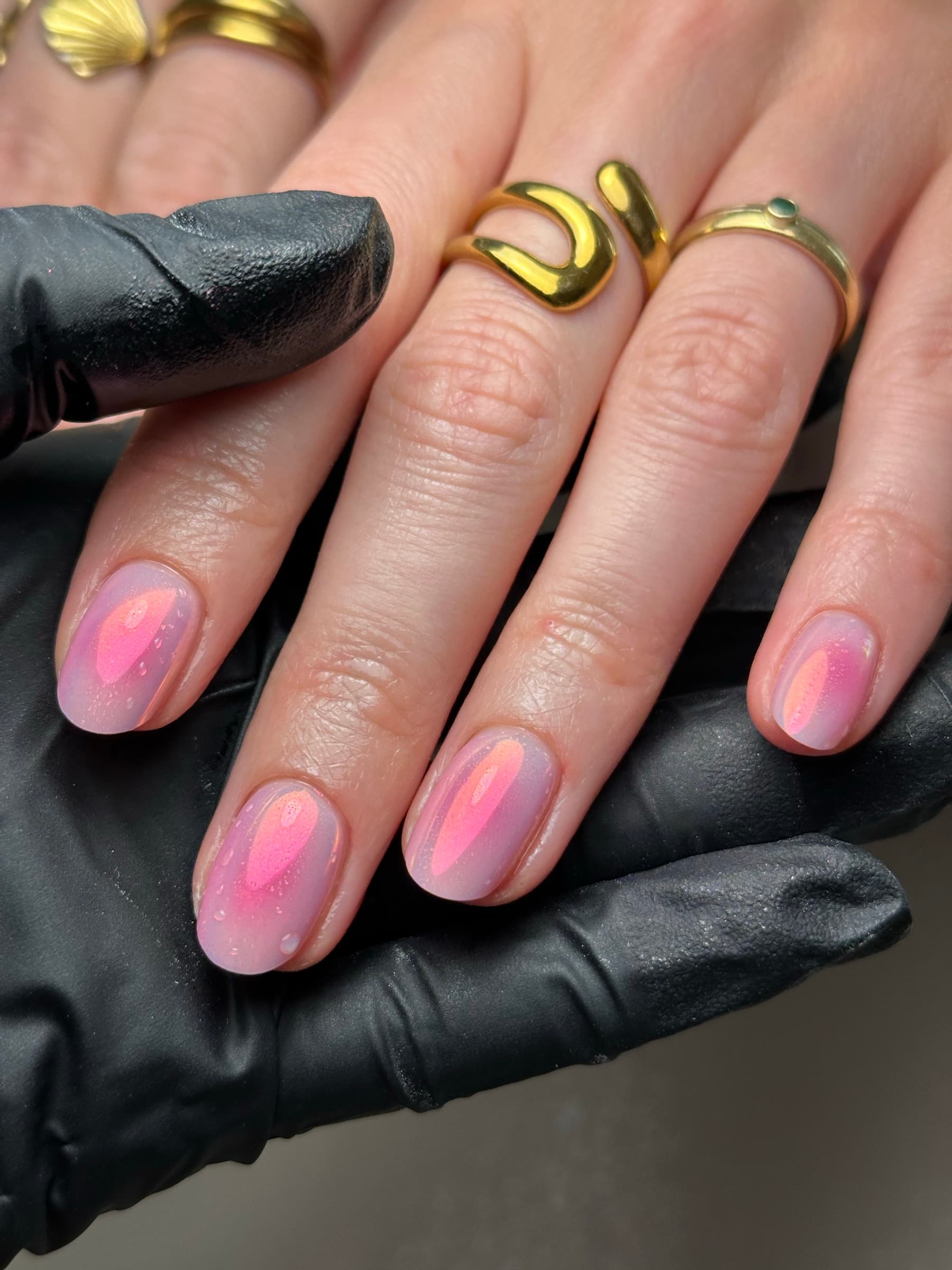 White nails with a hand-painted deer illustration, pink florals, and a glossy sage green accent nail