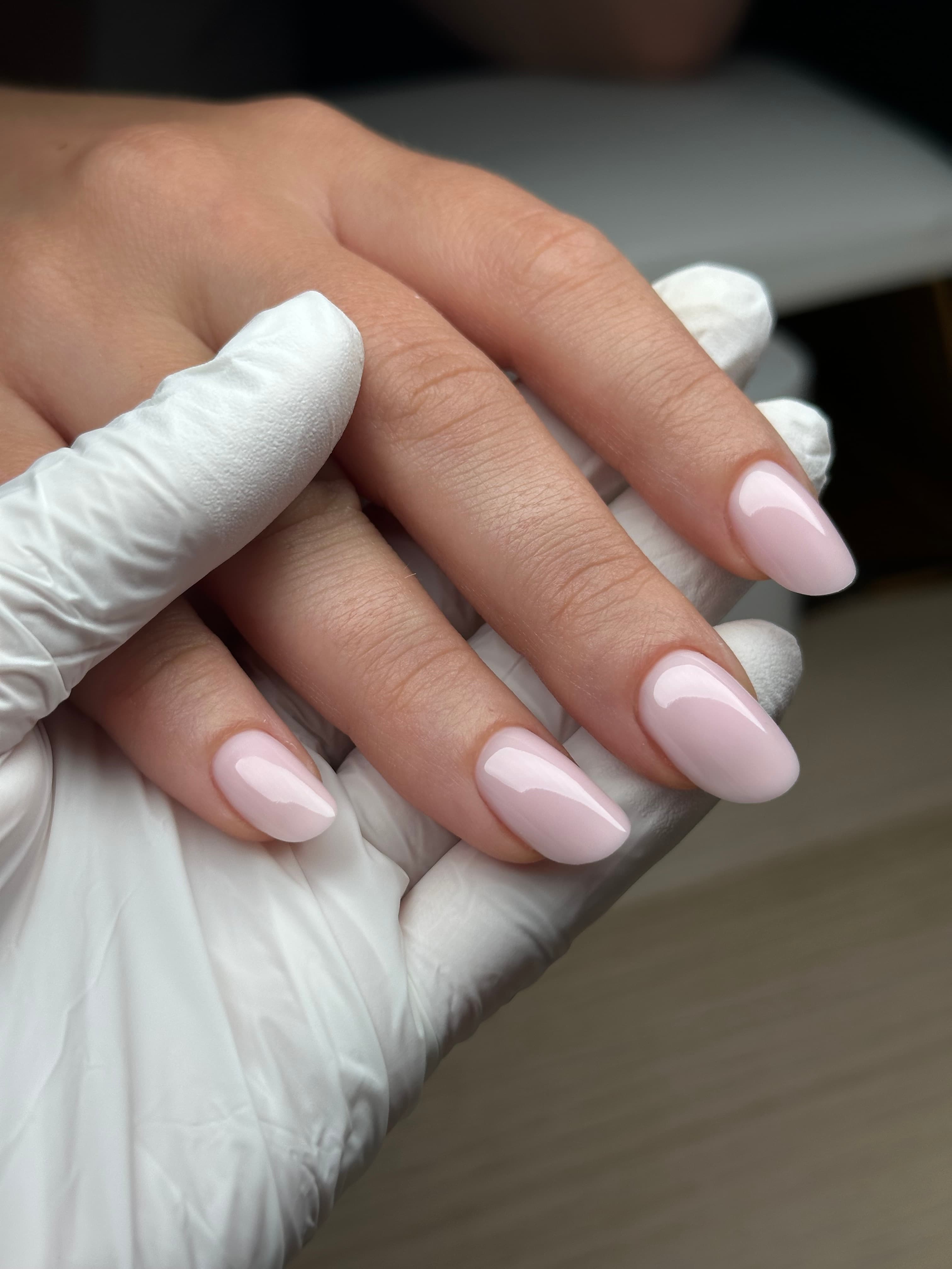 Glossy sheer milky pink oval nails with a clean, natural finish